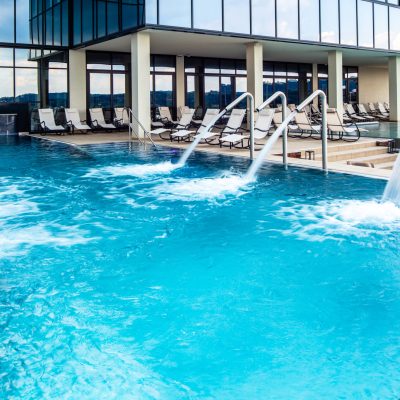 Empty swimming pool with hydrotherapy showers at health spa. Copy space.