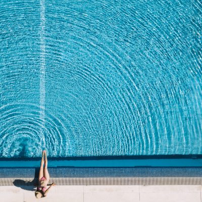 top-view-girl-relaxing-pool