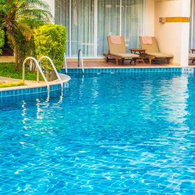 Empty Umbrella and chair around swimming pool in hotel resort